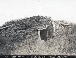 Solomon Butcher in front of his dugout. He wrote on the photo, "My first house in Neb. 1880. Built from ‘Neb. Brick’."