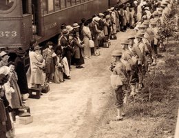 Japanese Americans arriving at Santa Anita by train from San Pedro California April 5, 1942. In his book, "Impounded", Gary Okihiro notes standard procedure was for photographers not to show certain scenes, such as soldiers with bayonets on their guns.