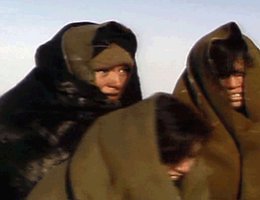 Three young women, shivering in blankets; A dramatization of the Ponca's trek from Indian Territory back to the Niobrara