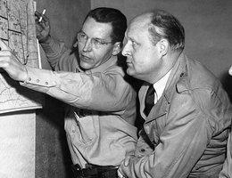 A relief worker explains Operation Snowbound details to Governor Val Peterson (center), 1949