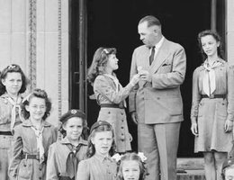 Gov. Dwight Griswold buying war bonds from a Girl Scout Troop on the steps of the Capitol in Lincoln