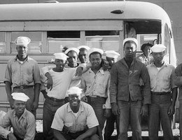 Housing the influx of black enlisted men was a problem. Eventually Hastings and the Navy built segregated housing developments. Here workers board a Navy bus to go to work. US Naval Ammunition Depot, Hastings, Nebraska; circa 1944.