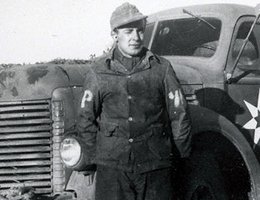 German POW in front of a camp truck at Fort Robinson, Nebraska; probably getting ready for a work detail, circa 1940s