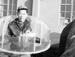 Sgt. Ben Kuroki poses with shattered turret, 1940s
