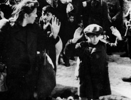 German storm troopers force Jewish people from the Warsaw ghetto to move with their hands up; Warsaw Ghetto — May, 1943, from "The Stroop Report: The Warsaw Ghetto is No More"