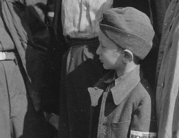 Six-year-old war orphan with Buchenwald badge on his sleeve, June 19, 1945