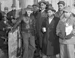 Striking Armour Co. packinghouse workers try to keep warm in south Omaha, 1948