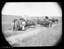 Emigrants in a wagon train arrive at the Gates Post Office in Custer County, 1886